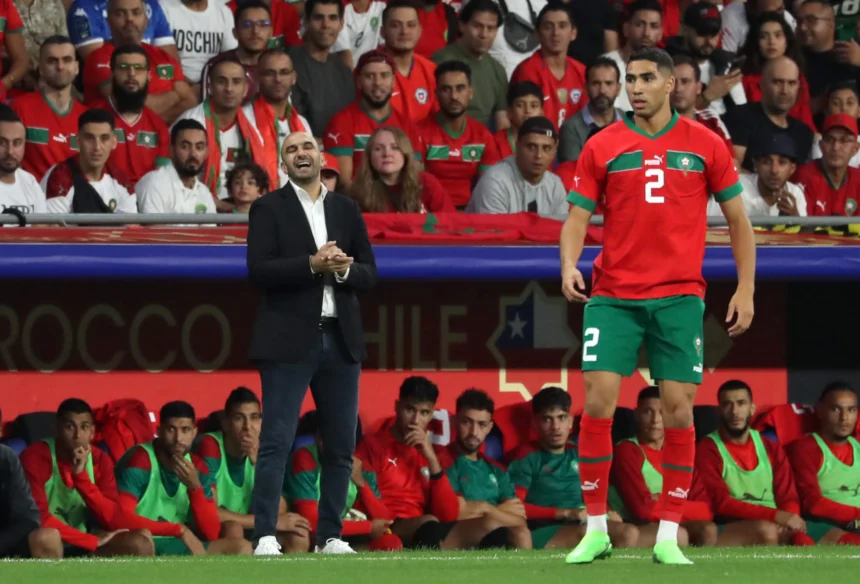 Morocco national team midfielders controlling possession, distributing passes, and driving play during an international football match, showcasing the engine room of the Atlas Lions.