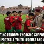 Families, supporters, and young football fans cheering from the stands during a Moroccan youth league match, creating an energetic community atmosphere around youth football development.