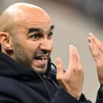 Morocco national team players arranged in a tactical formation on the pitch, illustrating Coach Walid Regragui's preferred starting lineup and strategic approach.
