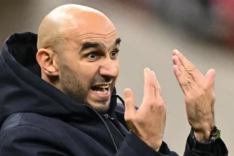 Morocco national team players arranged in a tactical formation on the pitch, illustrating Coach Walid Regragui's preferred starting lineup and strategic approach.