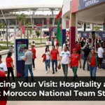 Morocco national team stadium fan zone filled with supporters, entertainment activities, food stalls, and premium hospitality areas during an Atlas Lions match day.