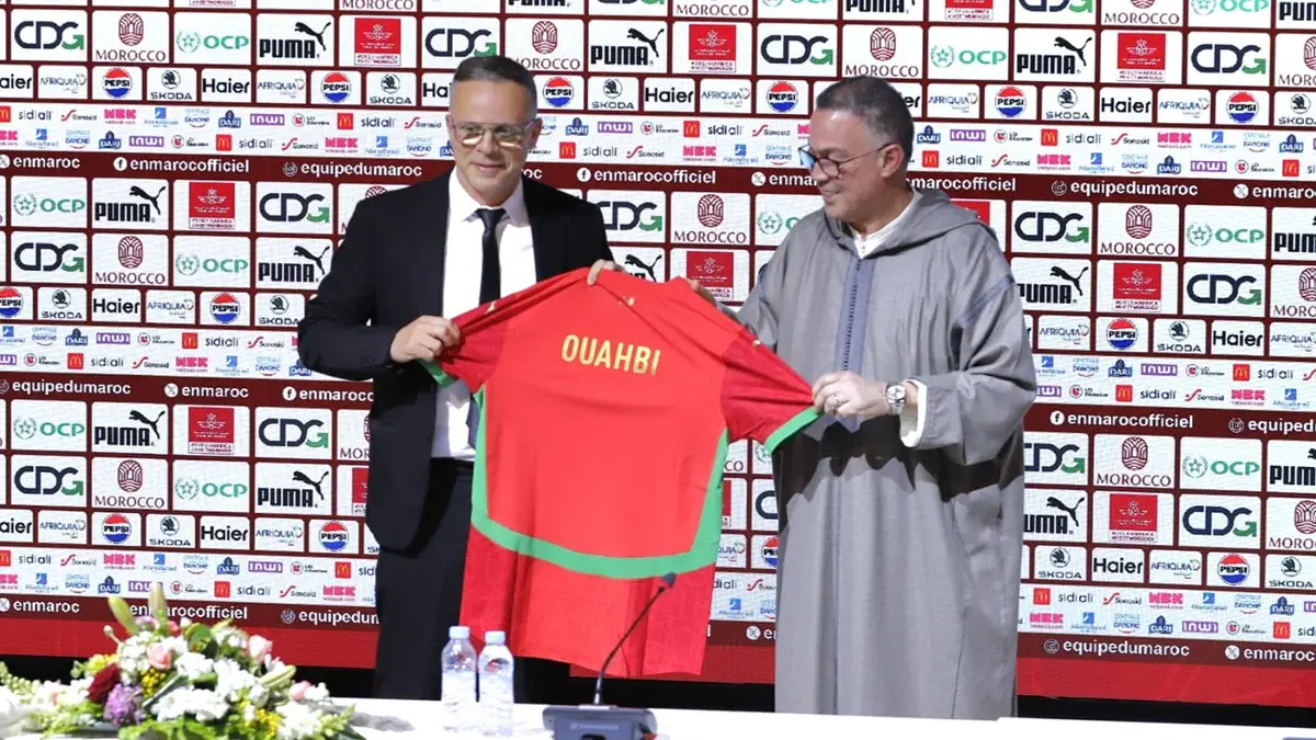 Morocco national team coaching staff and management team working from the sidelines during a match, coordinating tactics, player development, and team operations for the Atlas Lions.