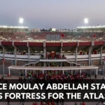 Prince Moulay Abdellah Stadium in Rabat hosting a Morocco national team match, with thousands of Atlas Lions supporters filling the stands and creating a vibrant atmosphere.