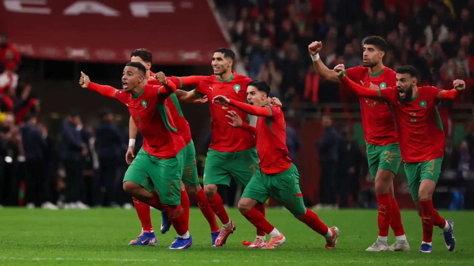 Morocco national team players competing in recent international matches, with a fixture board displaying upcoming games and tournament schedules for the Atlas Lions.