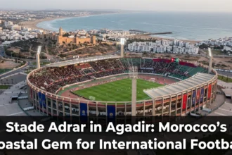 Stade Adrar in Agadir, Morocco, a modern 45,000-seat football stadium on the Atlantic coast, hosting international matches and major tournaments against the backdrop of the Atlas Mountains.