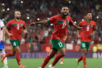 Morocco national team players with experience in European football leagues celebrating together, highlighting the influence of overseas-based talent on the Atlas Lions' success.