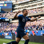 Alt Text Kylian Mbappe celebrates during France’s 3-1 World Cup win over Senegal at MetLife Stadium.