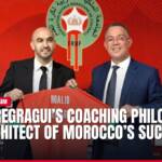 Moroccan football coach Walid Regragui holding jersey with official.