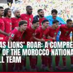 Morocco national football team players in red jerseys smiling on field.